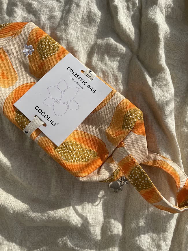 Papaya-print Cocolili cosmetic bag on linen