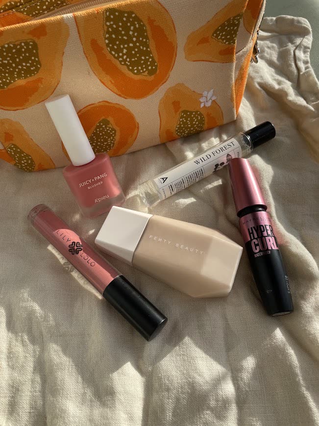 Make-up products laid out in soft sunlight